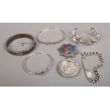 A quantity of silver items including an identity bracelet, books of Rhodesia limited edition brooch,