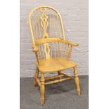 A hardwood spindle back Windsor arm chair.