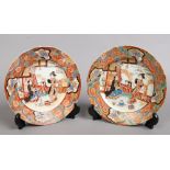A pair of Japanese Meiji period Kutani plates. Each painted with figures in outdoor settings under