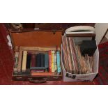 A suitcase containing vintage children's books and a box of L.P records, 78s, 45s, mirrors, pictures
