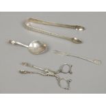 Four pieces of silver including a pair of Georgian sugar tongues, pickle fork, spoon etc, gross