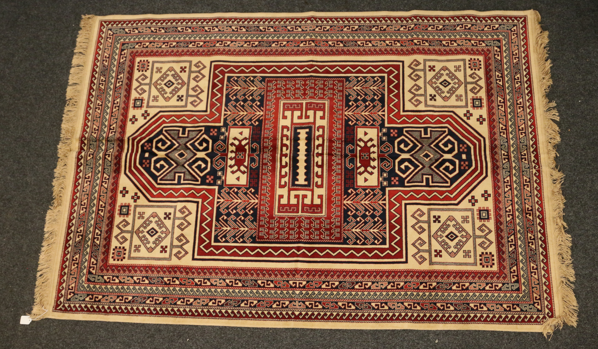 A cream ground geometric design rug, 207cm x 135cm.