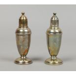 A pair of weighted silver pepper pots.