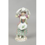 A 20th century Meissen figure of a rural girl collecting vegetables. Coloured in enamels and