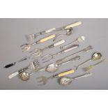 A collection of Victorian and later silver plated utensils including toasting fork etc.