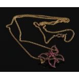 A 9ct gold butterfly pendant set with rubies on 9ct gold chain.