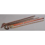 A bamboo pace stick and three walking sticks, one of stepped malaca and two carved in the form of