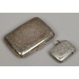 An Edwardian silver cigarette case chased with scrollwork decoration, along with silver vesta