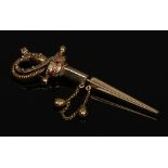 A novelty yellow metal brooch formed as a short sword with separate scabbard and having three rubies