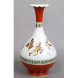 A porcelain bottle vase. With red ground and key fret borders and decorated with a continuing band