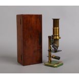 An early 20th century lacquered brass field microscope in mahogany case. Condition report intended