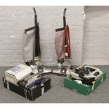 Two Kirby Heritage II vacuum cleaners and two boxes of associated accessories.