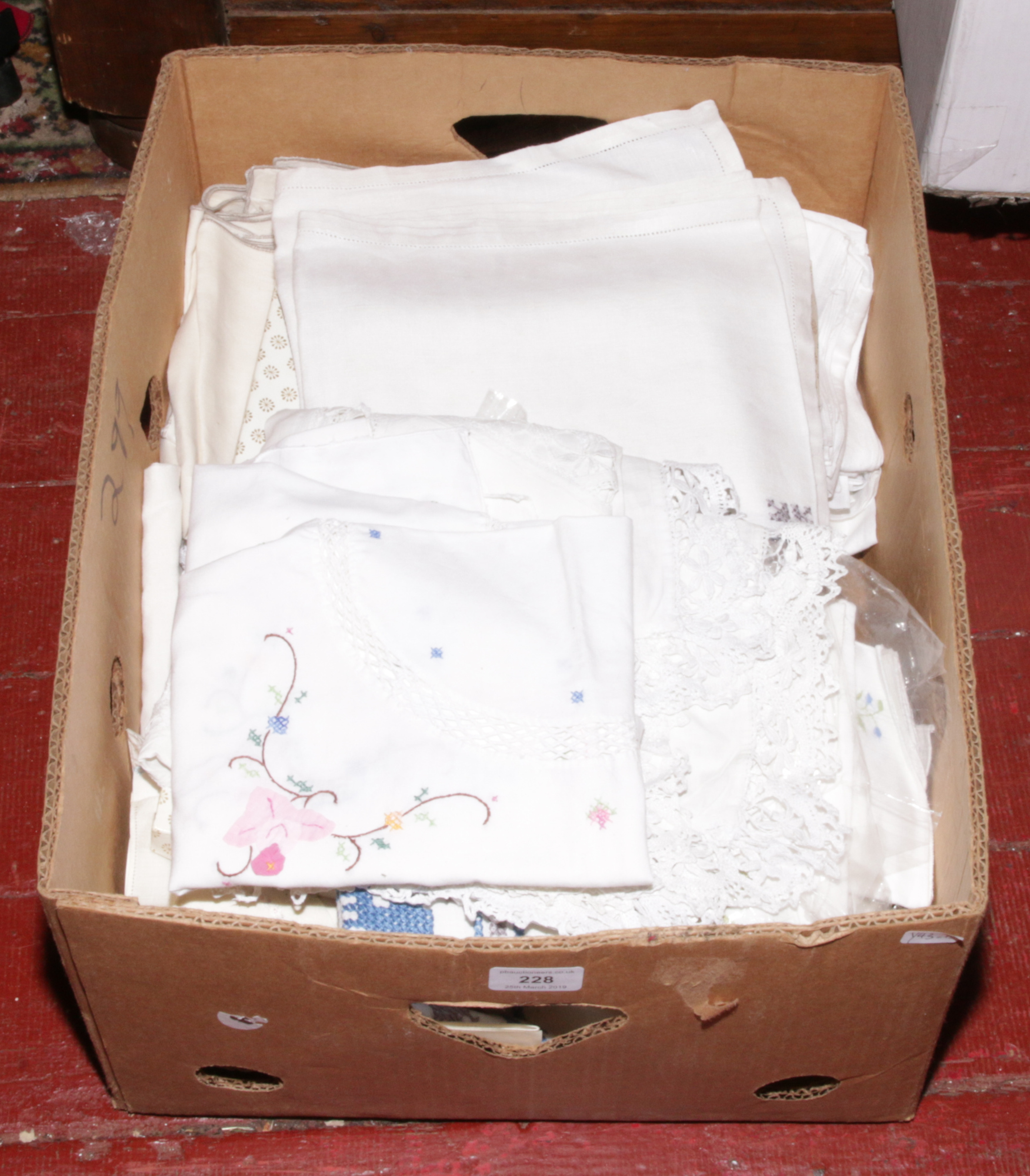 A box of mixed lace and linen.