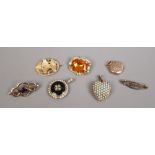 A quantity of yellow metal jewellery including coloured stone set brooches a heart shaped locket