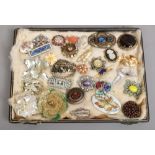 A tray of costume brooches to include colour paste stone set examples etc.