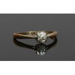 A 9ct gold and platinum solitaire diamond engagement ring. Set with a brilliant cut diamond