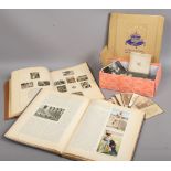 A box of vintage photographs, along with three vintage books Coronation Souvenir 1937, Olympia