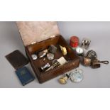 A carved oak box of collectables to include vintage tin, magnifying glass, wallet etc.