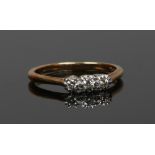 An 18ct gold and platinum three stone diamond ring, size O 1/2. (Weight 2.4g)
