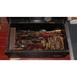 A metal trunk and contents of mostly wood working tools including planes, drills, sockets sets etc.