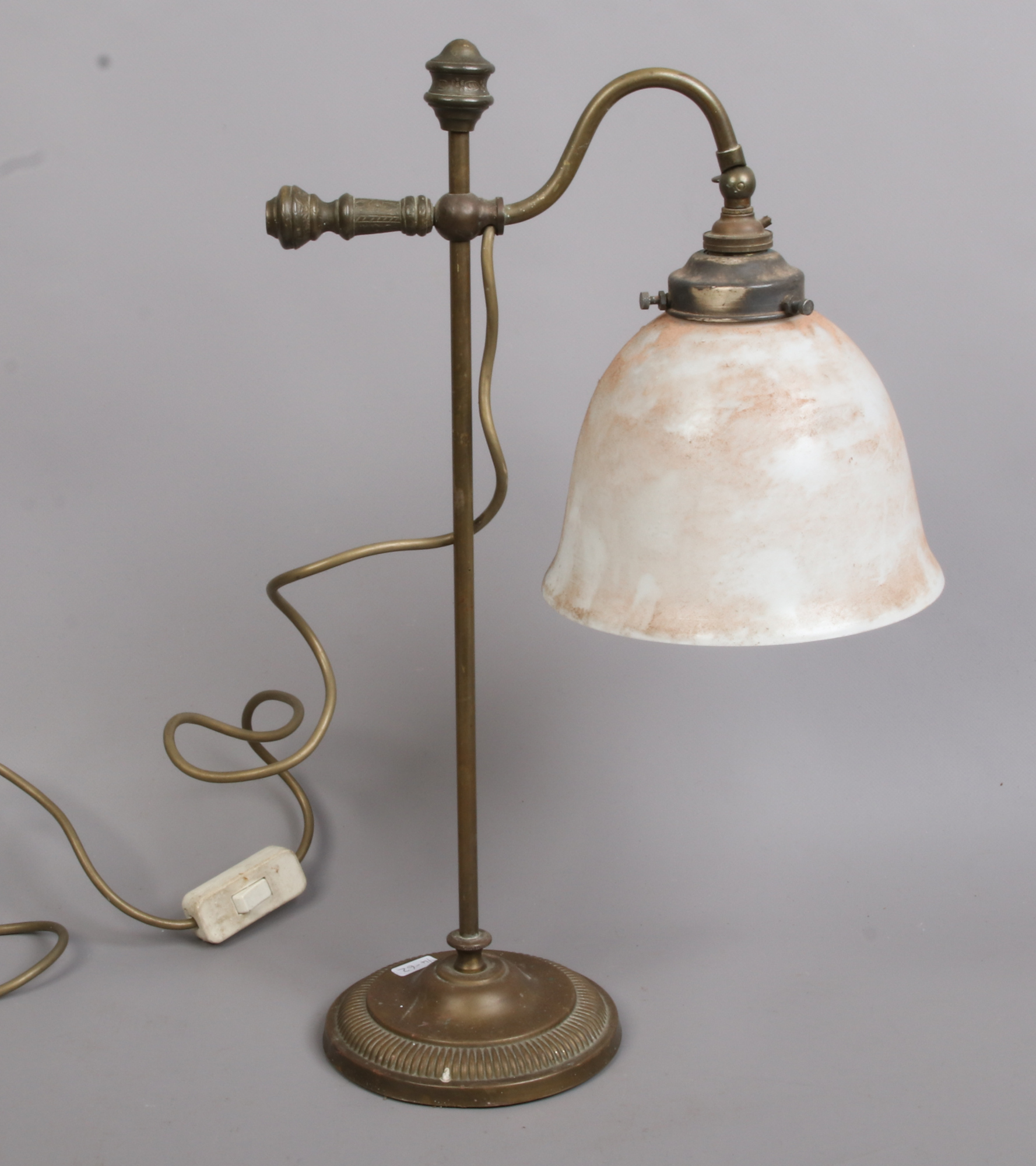 A bronze rise and fall adjustable students lamp with glass shades.