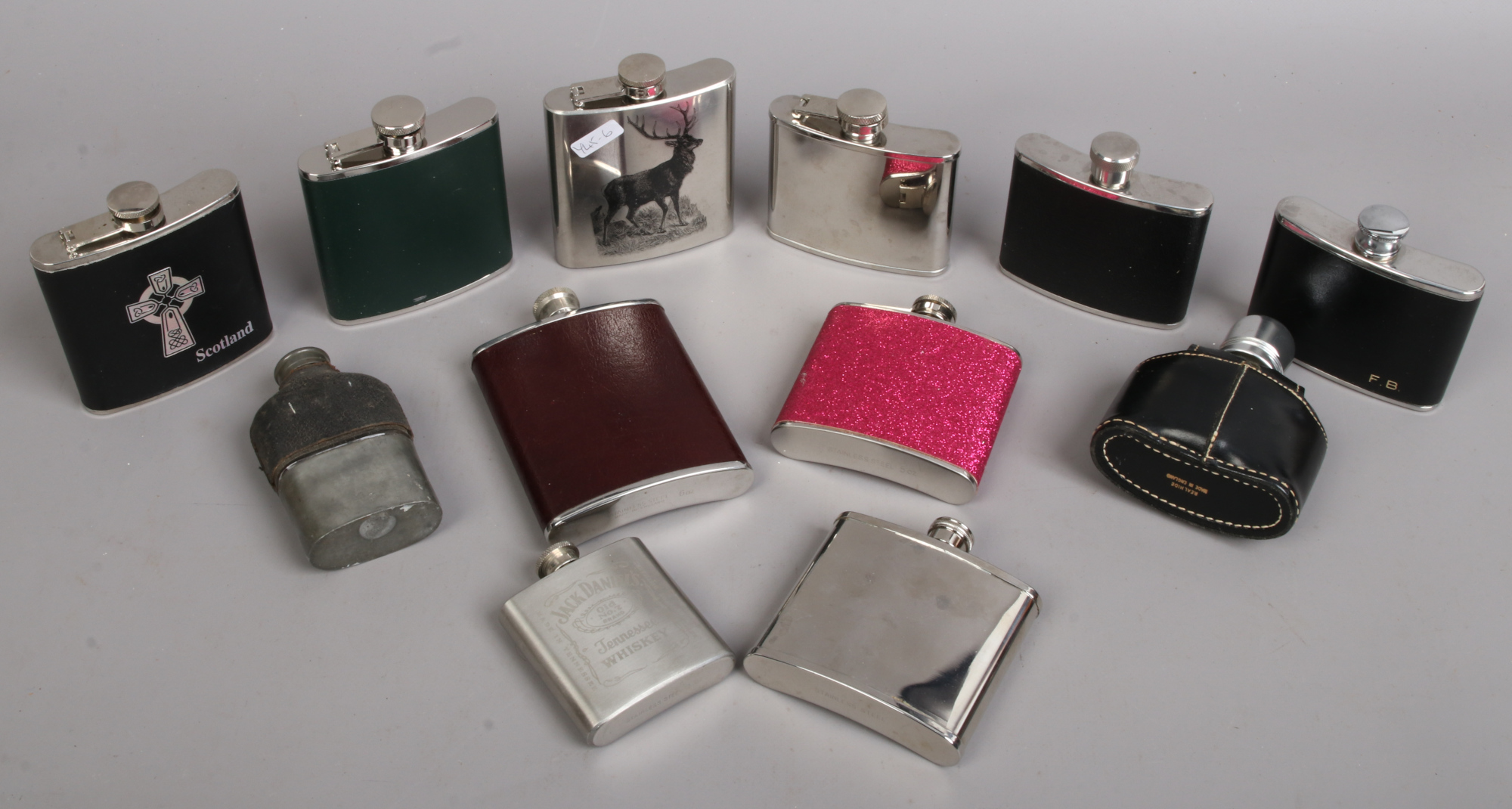 Collection of assorted hip flasks including leather mounted examples.