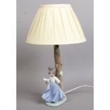 A Nao table lamp formed as a tree with a young girl holding a dove.