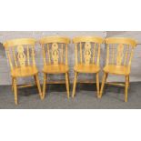 A set of four hardwood dining chairs with turned supports.