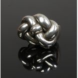 A large white metal knot ring inscribed Para Mi to the side, size Q.