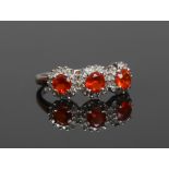 A 9ct white gold, fire opal and diamond dress ring, size L.