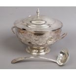 A silver plated soup tureen and cover with ladle.