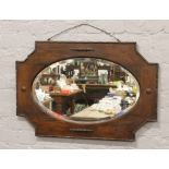A Victorian carved oak bevel edge wall mirror.