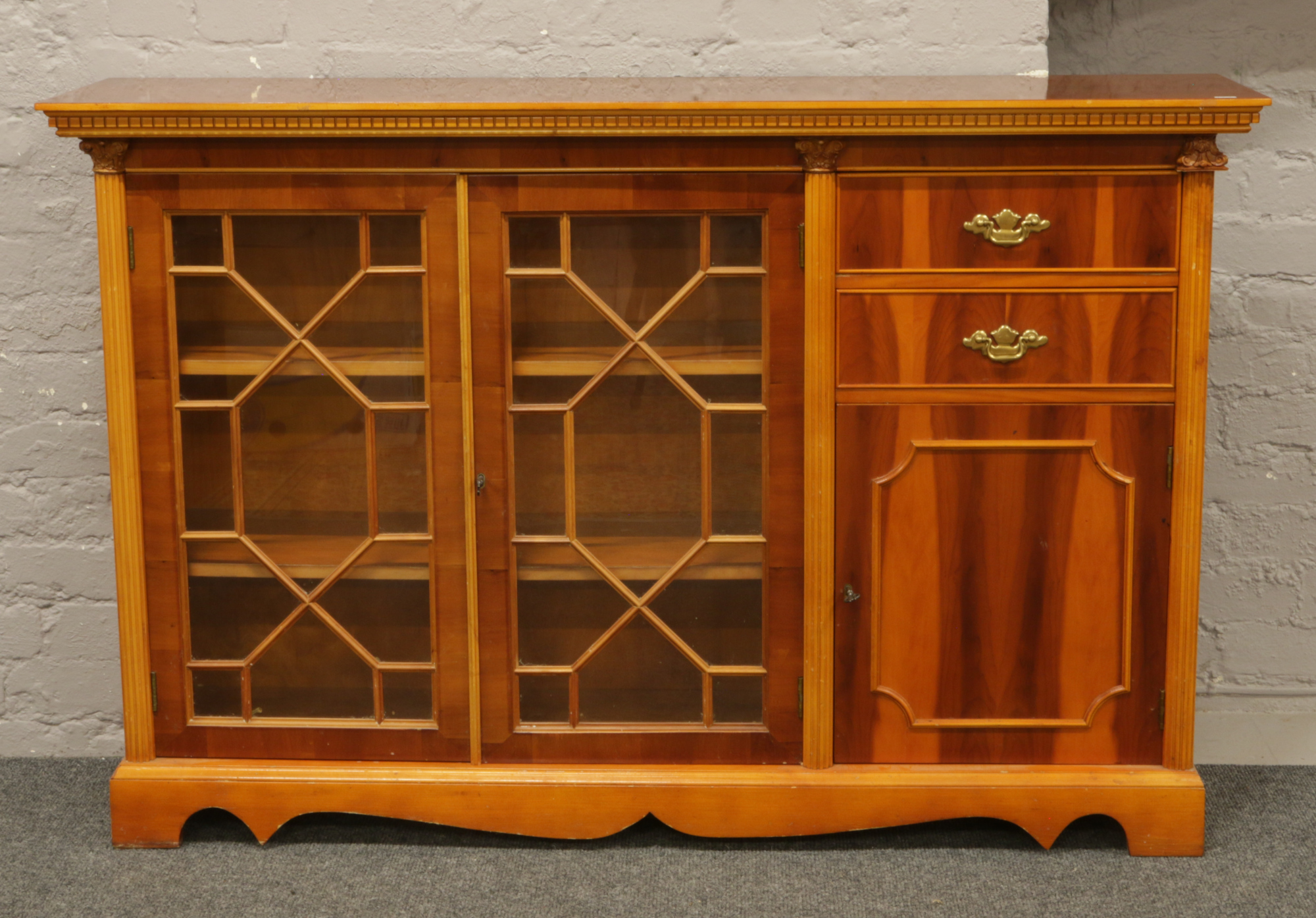 A yew wood astrigal glazed display side cabinet.