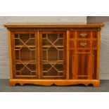 A yew wood astrigal glazed display side cabinet.