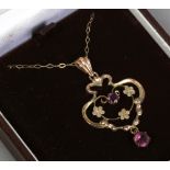 An Edwardian 9ct gold pendant and chain set with two amethyst.
