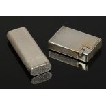 A silver plated Cartier lighter with engine turned engraving and a Dupont lighter.