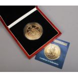 A cased The Worlds largest Britannia and St George and The Dragon commemorative coin by The London