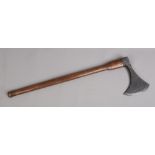 A 19th century iron axe head on later wood handle.