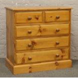 A pine chest of five drawers.