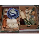 Two boxes of mostly stoneware storage jars and glass advertising bottles, along with a Genever
