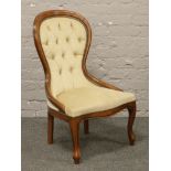 A mahogany deep buttoned spoon back chair.