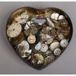 A tin of assorted pocket watch and wristwatch movements and other spares.