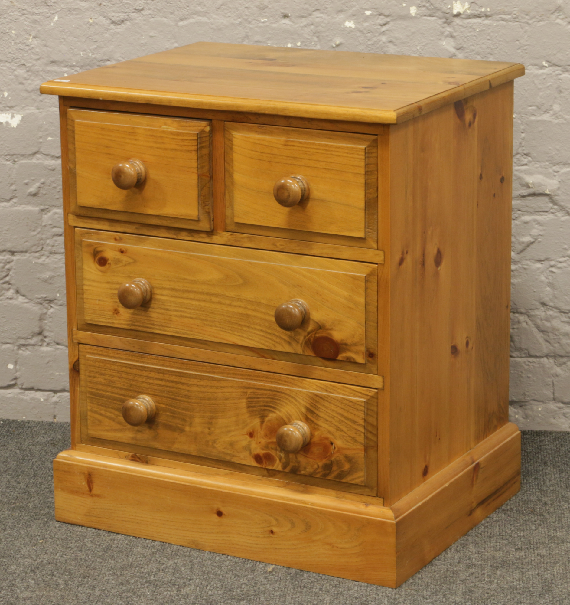 A small pine chest of four drawers.