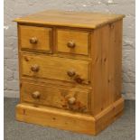 A small pine chest of four drawers.