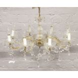 A cut glass eight branch chandelier with cut glass droplets.