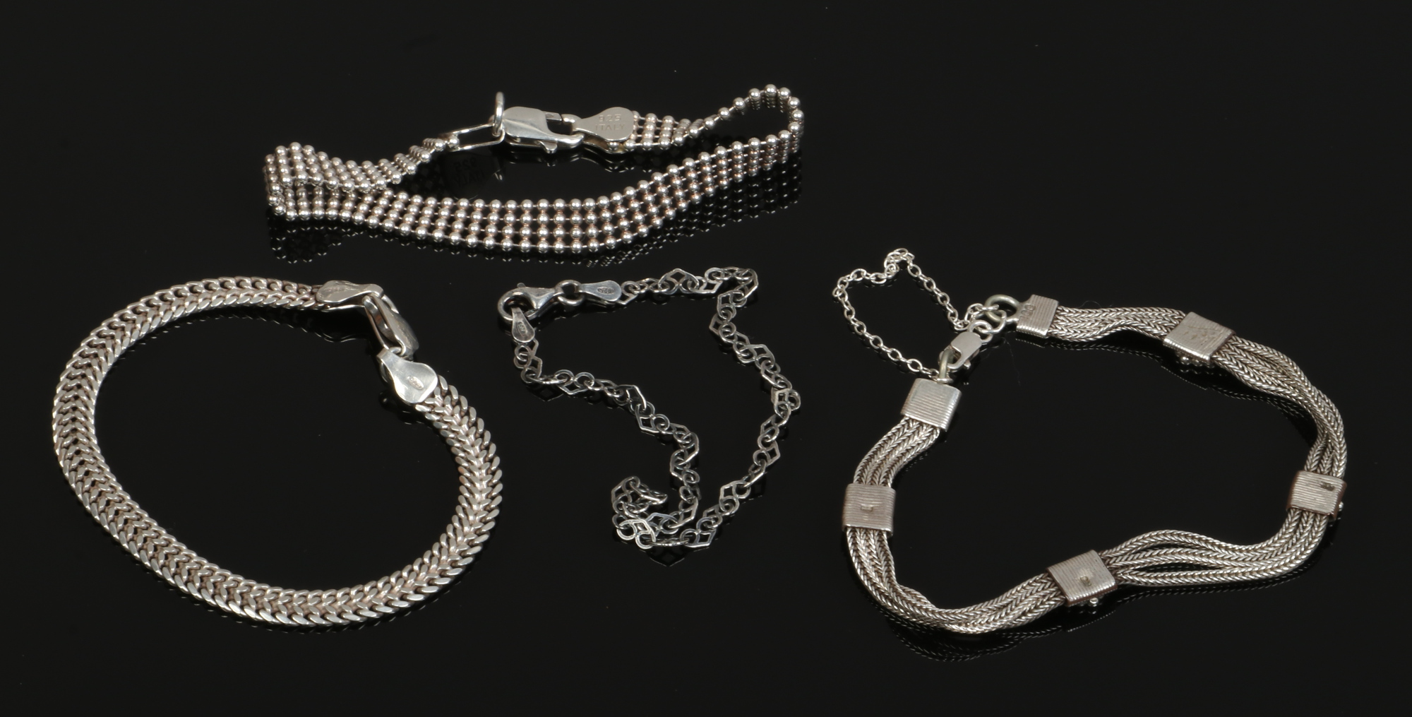 Four silver bracelets total silver weight 26 grams.