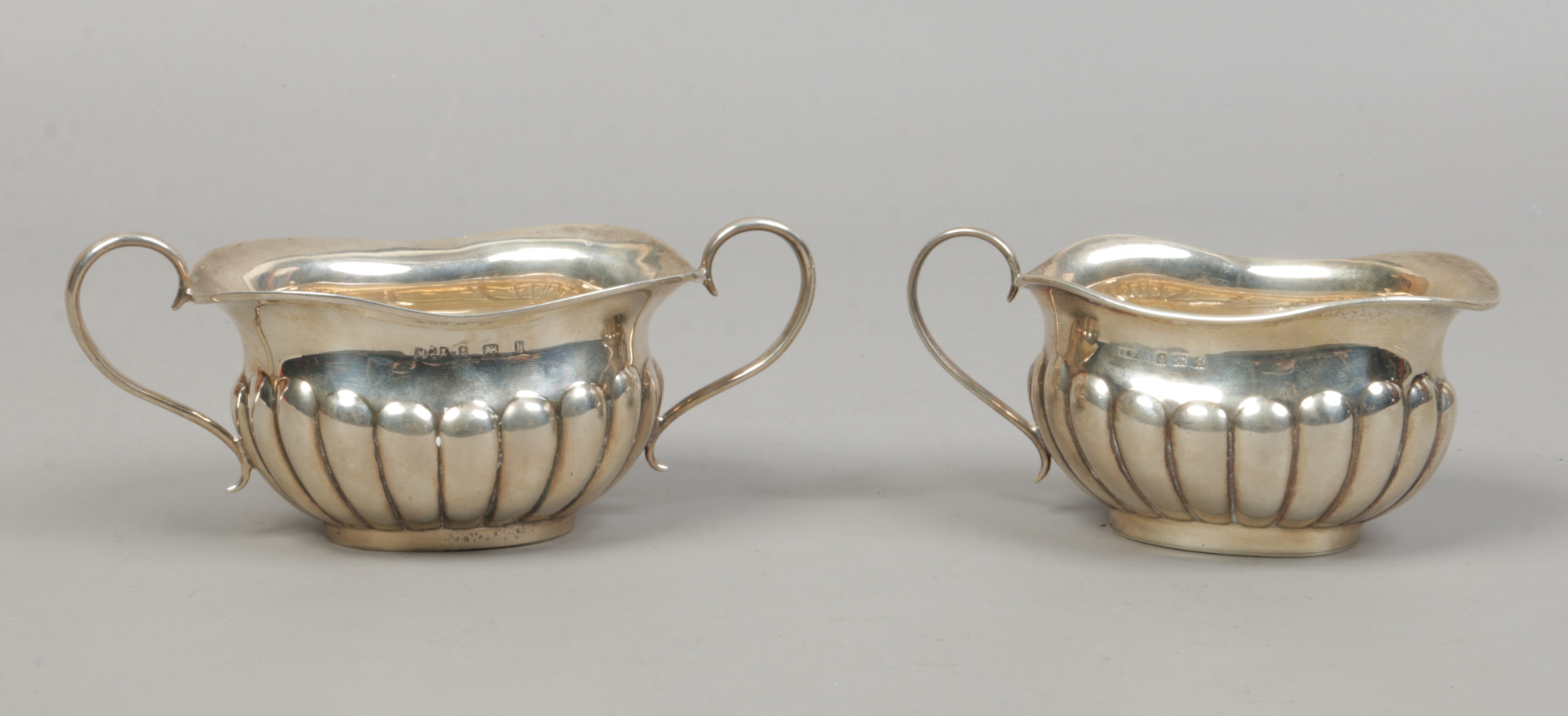 A matched silver cream jug and sugar bowl, assayed Birmingham 1901 and 1938, 217 grams.