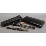 A cased clarinet along with a Flatters & Garnett Limited microscope case.
