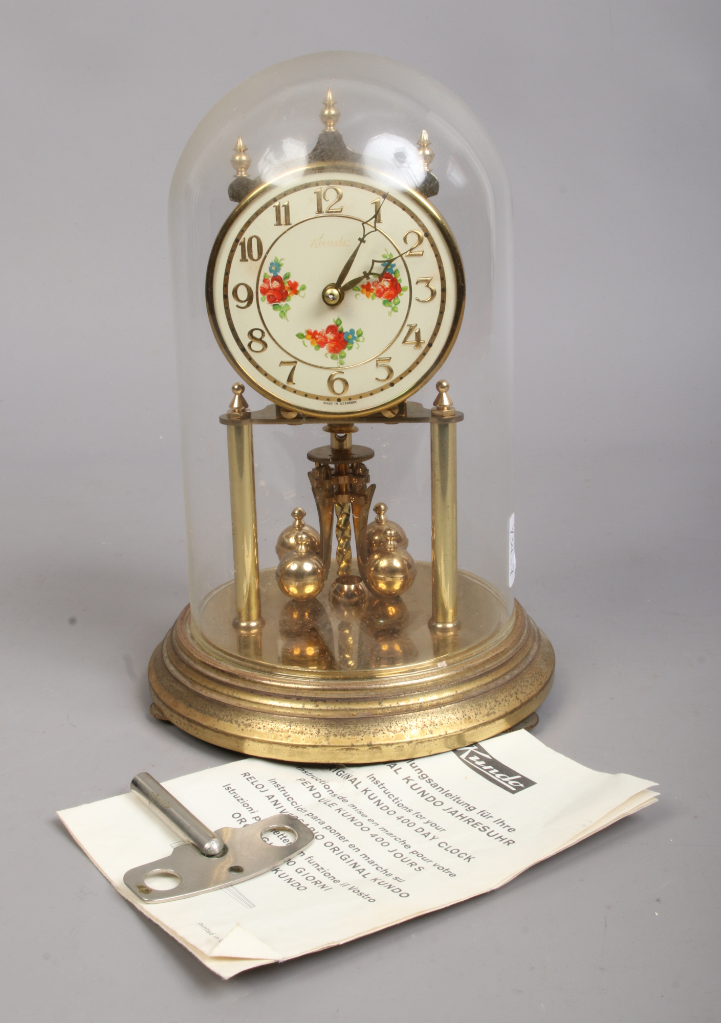 A brass 400 day anniversary clock, maker Kundo, Germany. Under glass ...