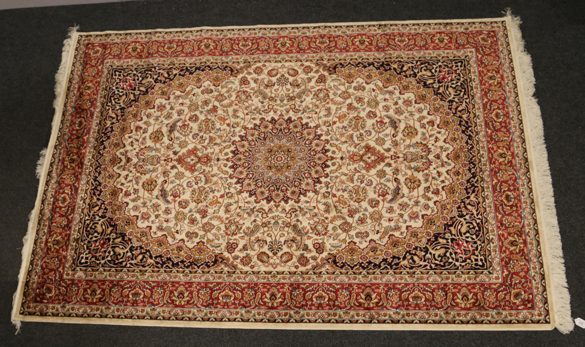 A beige ground Keshan carpet, 230cm x 160cm.